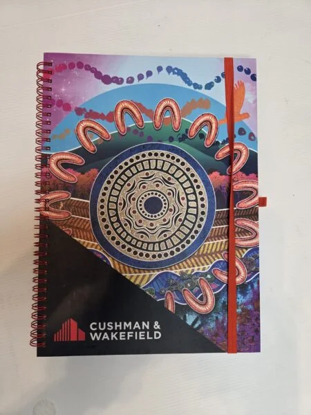Colorful spiral notebook with Indigenous art—perfect for event gift ideas, no size required.