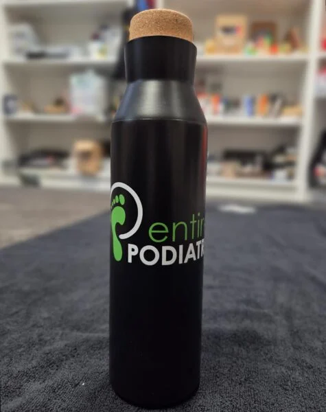 Black bottle labeled Entire Podiatry—perfect for advising clients when choosing similar products.