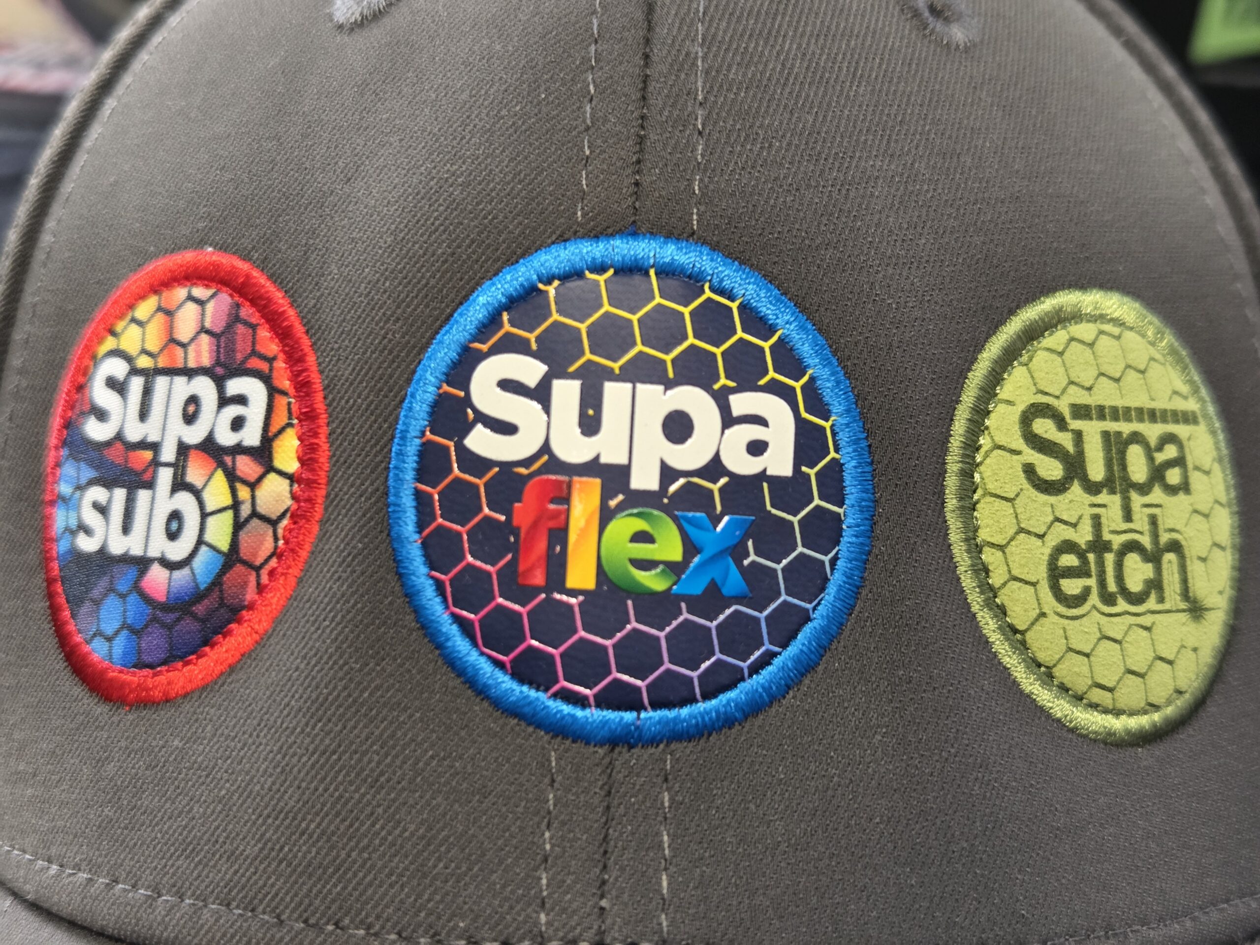 Three colorful circular patches—great for choosing products or offering client advice—on gray fabric.