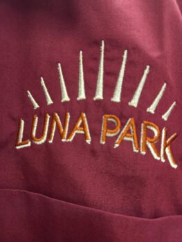 LUNA PARK embroidered in yellow and white on red—perfect for team uniforms or unisex apparel.