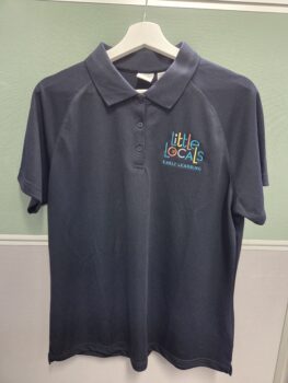 Dark unisex polo shirt with Little Locals Early Learning logo hanging on a white hanger.