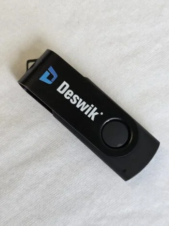 Black Cap USB drive on a white surface.