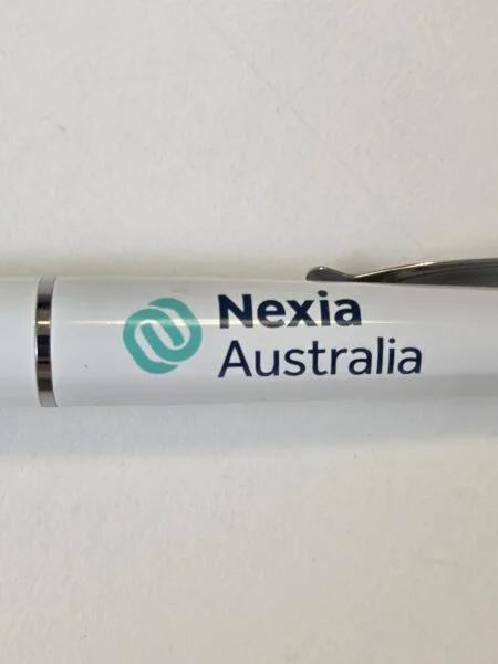 White pen with Nexia Australia logo—ideal for retail inventory or reorder merchandise needs.