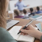 Student taking notes with a Parker Pen Jotter Series during a lecture.