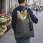 Man with groceries, bread & flowers in Ashton Recycled 3-Pack Shopper Tote Bags on city street.