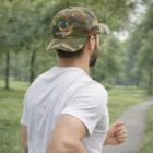 Man wearing the Wilderness Trucker hat runs on a trail through lush green wilderness.