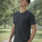 Man on a park path in Men's Cool Cotton Rich Tee, eyes closed, enjoying the sunlight.