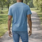 Man in Gildan Softstyle Adult T-Shirt and jeans walking down a park path, seen from behind.