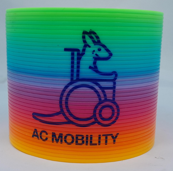 A rainbow slinky with a kangaroo in a wheelchair and AC MOBILITY printed on it.