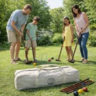 A family in Norwich plays with Norwich Backyard Croquet Sets; a bag sits on the grass.