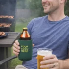 Smiling man holds beer with Your Logo Here sleeve, Coolers Without Base set beside him.