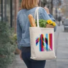 Woman with Lewes Eco Event Bags Medium 280Gsm carrying groceries and flowers on city sidewalk.