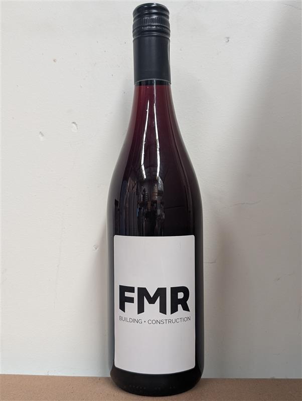 A wine bottle labeled Fox Metal Roofing • Construction against a plain background.