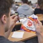 Person cleaning lenses with Essex Microfibre Lens Cloths at a Melbourne Science Festival classroom.