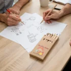 Two people sketching with Tourer Corporate Pencil Sets at a wooden table.