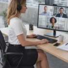 Woman in headset wears Business Style Pencil Skirts, video conferencing with three colleagues.