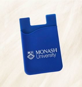 Blue silicone phone card holder printed with the Monash University logo in white