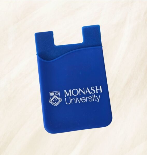 Blue card holder with Monash University logo, photographed on a light, textured background in Melbourne.