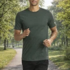 Man jogging in a sunny park, wearing Nike Dri-Fit Cotton Poly Tee and black shorts.