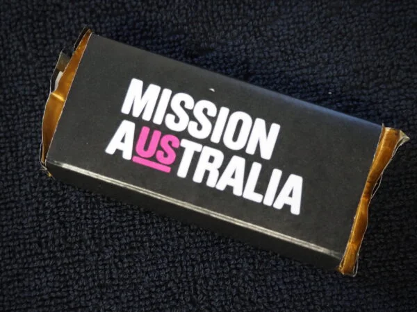 A black box with MISSION AUSTRALIA highlighted, perfect for product comparison photos.