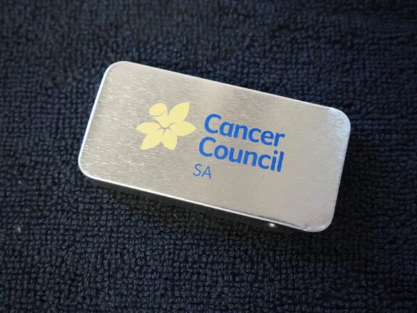 Rectangular metal item with Cancer Council SA logo, ideal for Australia community events.