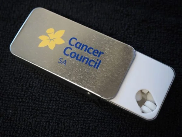 A metal Cancer Council SA tin with mints, perfect for community events across Australia.