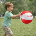Young boy playing outdoors on grass with a 30cm Beach Balls 30Cm.