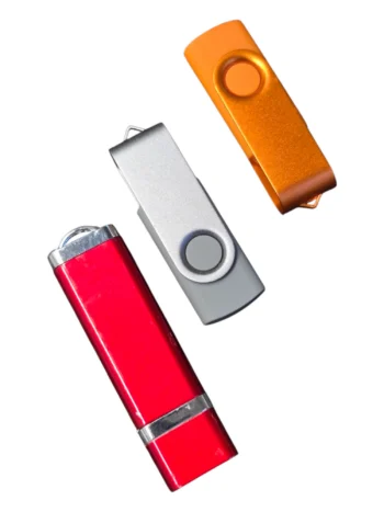 Three USB flash drives with USB data preloading on a white background.