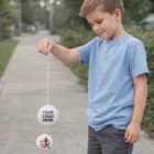 Smiling boy playing outdoors with Promotional White Yo Yos featuring Your Logo Here.