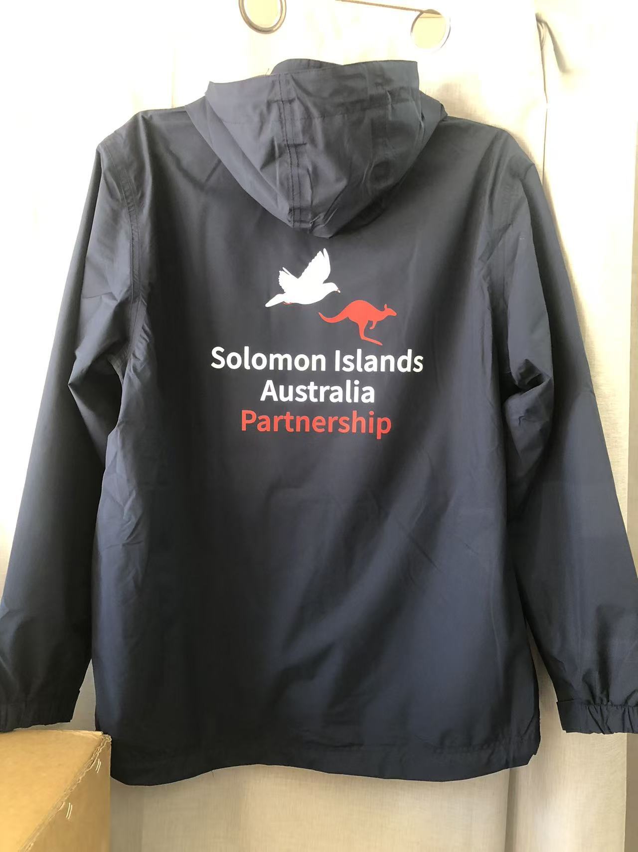 Navy jacket with SIIP, Solomon Islands Australia Partnership, dove and kangaroo symbols on back.