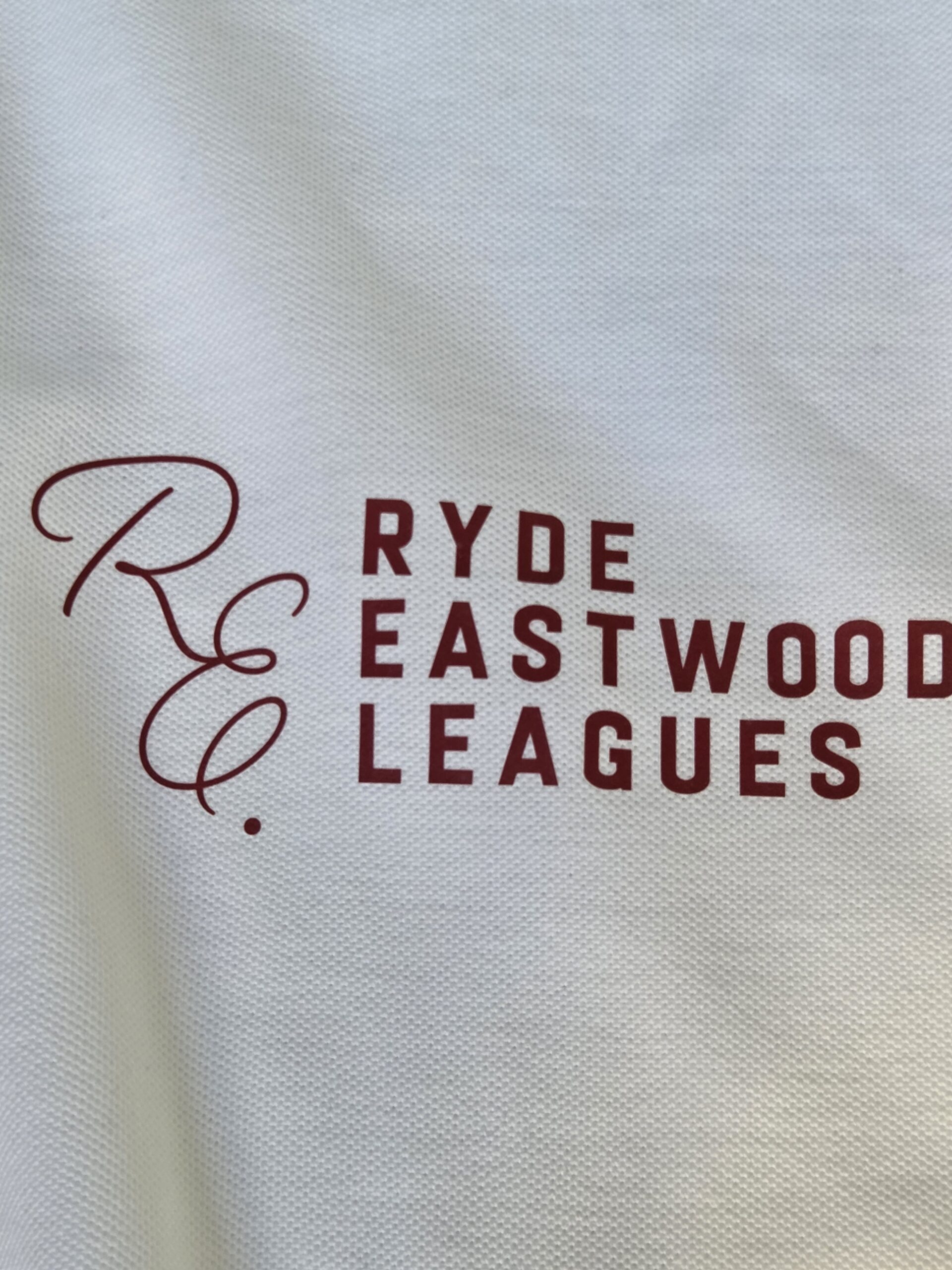 Red text R.E.C. Ryde Eastwood League on a white fabric, ideal for Rugby League fans.