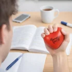 Someone studies with a Stress Ball Heart that reads “Always and Forever.”.