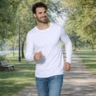 A man wearing Men's Alfie Long Sleeves jogs on a tree-lined park path.