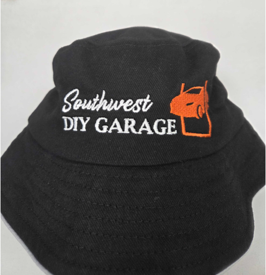 Black bucket hat with Bunbury’s Southwest DIY Garage and an orange car logo embroidered on it.