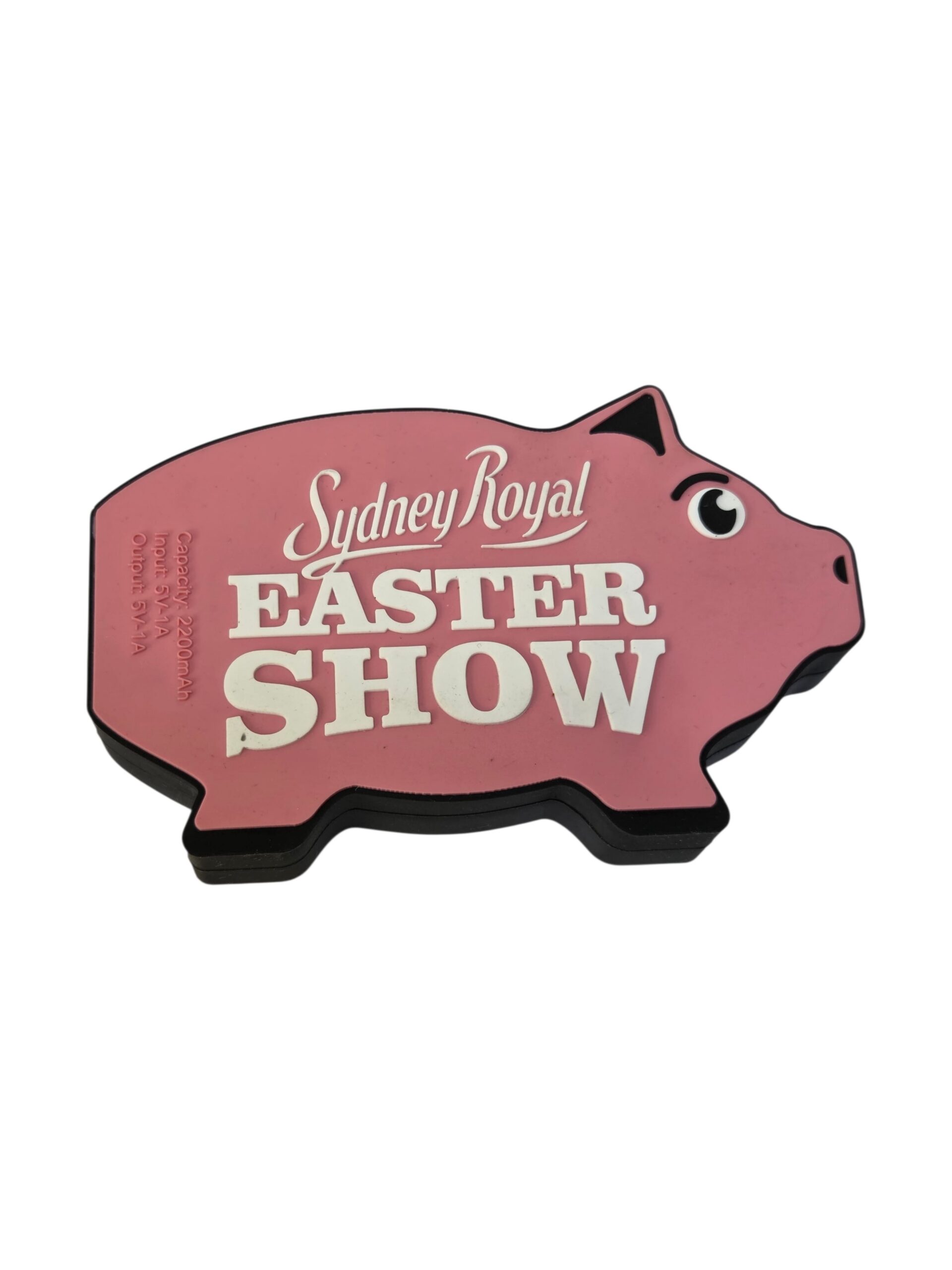 Pink pig-shaped sign with Sydney Royal Easter Show written on it in white letters.
