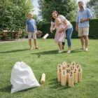 Family playing Trekk Skittle Throw Game on grass using numbered wooden pins and a throwing stick.