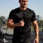 Man in Cool Dry Customised Mens T Shirt jogging outdoors on a sunny day.