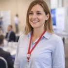 Woman in a light blue shirt wears an Unprinted Bootlace Lanyard at a professional event.