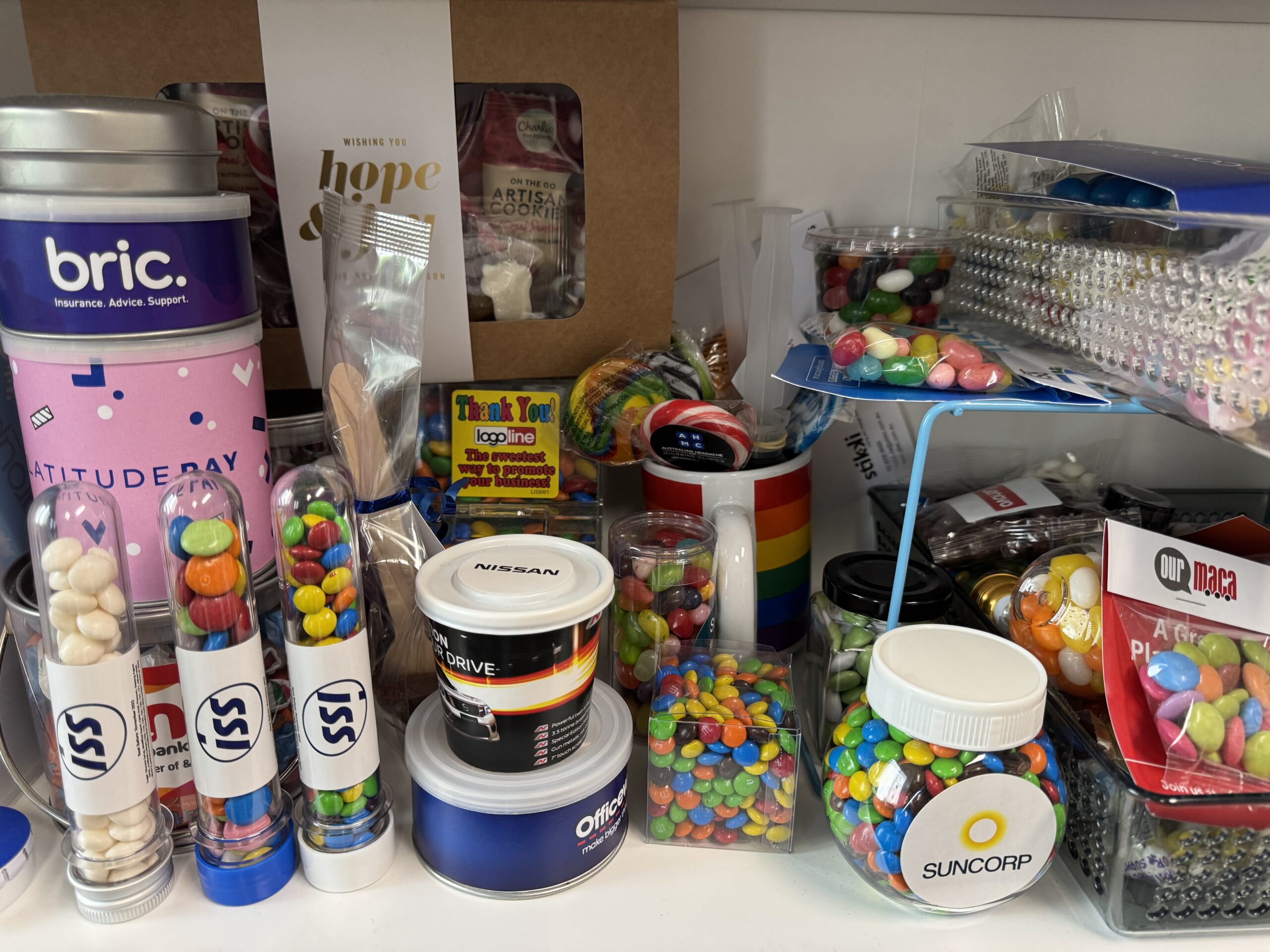 Assorted jars and containers filled with colorful candies await the delivery process on a shelf.