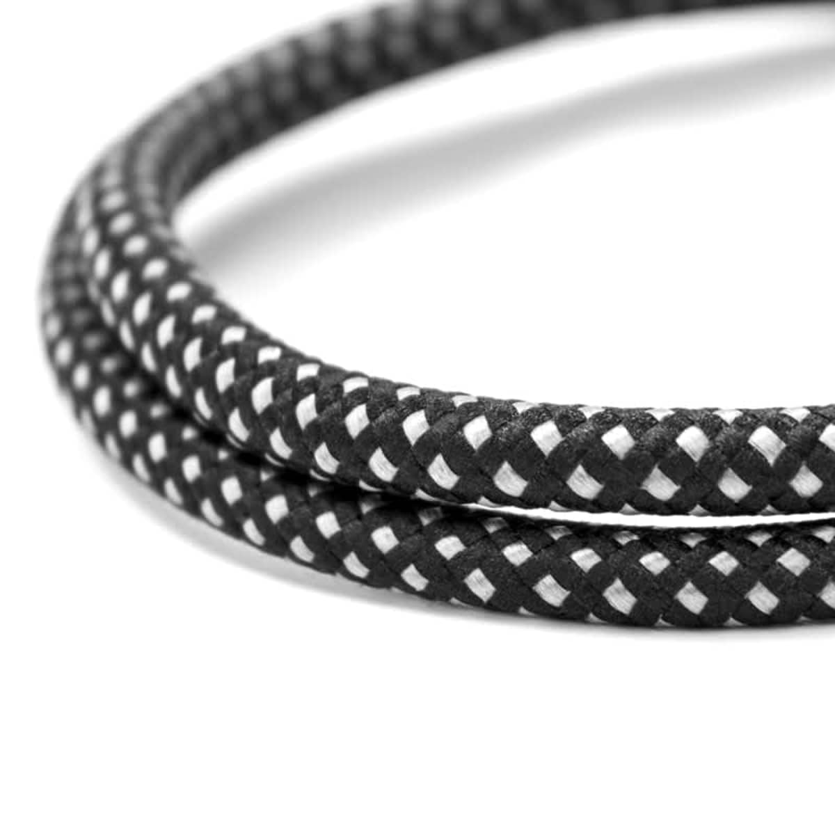Close-up of a black and white braided rope coiled in a loop on a white background.