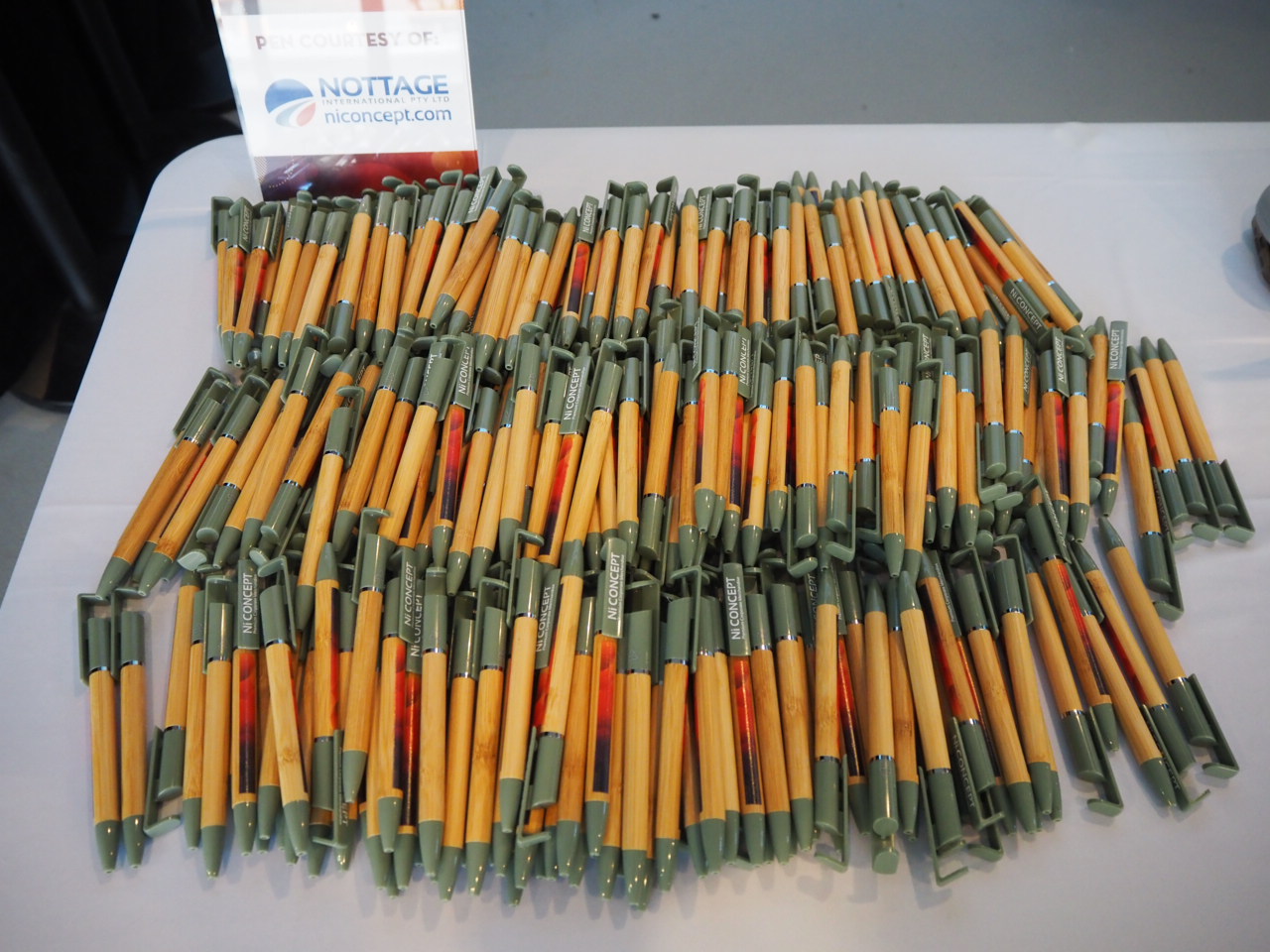 Many green and yellow pens are arranged on a table, ready for university events or Open Day.