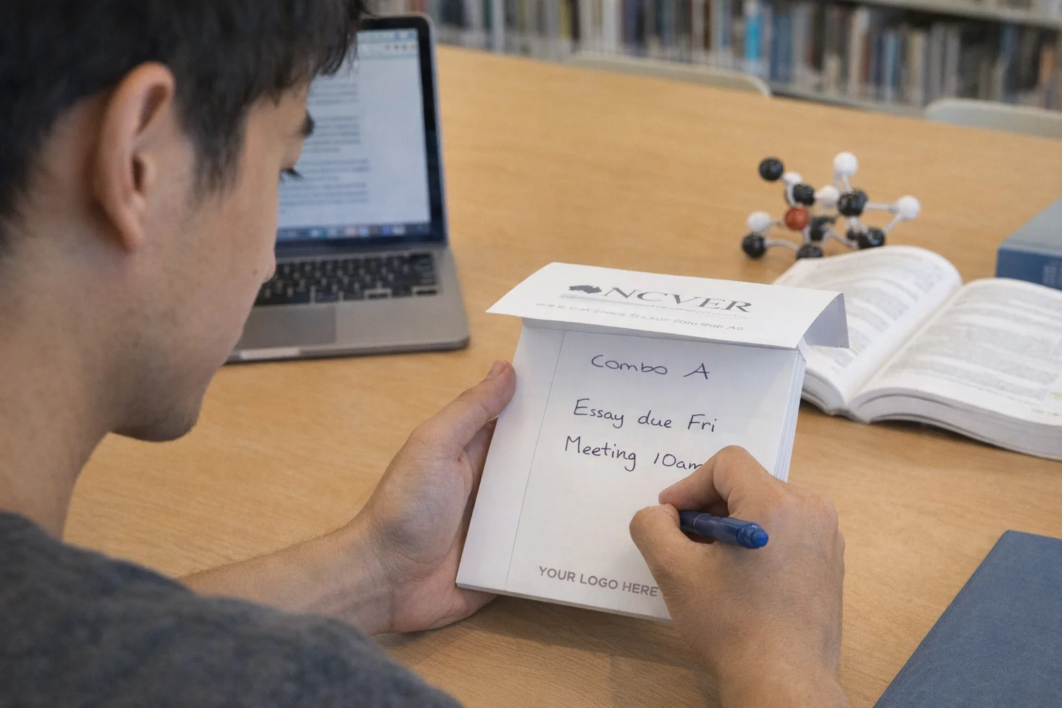 Sticky Notes Combo A on desk with laptop, books; essay writing, meeting at 10am.