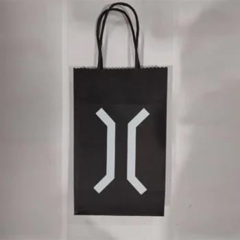 Black gift bag with a white Complex Co geometric symbol and two black handles, on a white background.