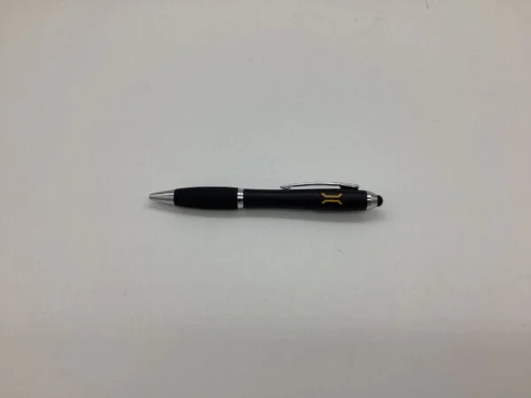 A black Complex Co pen with silver accents lies on a plain white surface in Sydney.