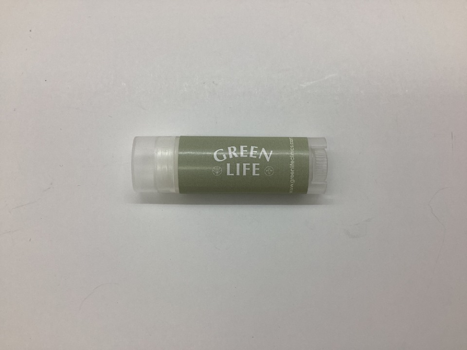 A tube of Green Life lip balm, a must-have among wellness items, on a white background.
