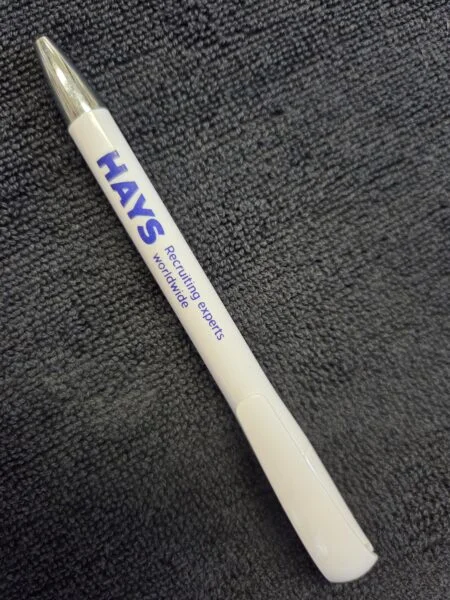 White HAYS pen with blue text on a textured dark gray surface for Aussie business needs.