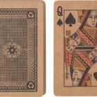A deck of playing cards with the Queen of Spades showing and the card back design visible.