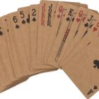 A fanned deck of brown playing cards, including jokers, spades, hearts, and clubs.