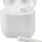 White wireless earbuds, one in its open charging case and one outside on a white background.