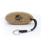 Oval cork keychain with JR TRAVEL logo and a black cord attached to a metal keyring.